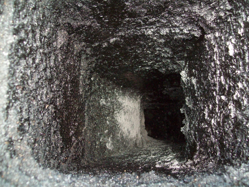 Dark narrow mine shaft tunnel interior.