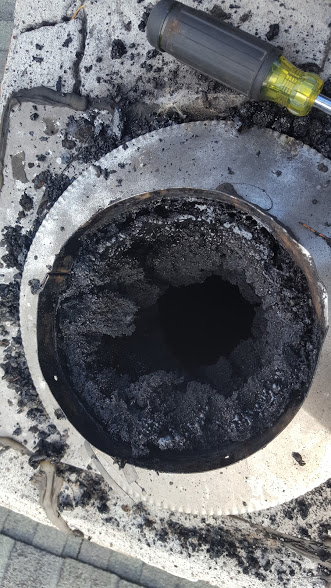 Charred remains inside barbecue grill after use.