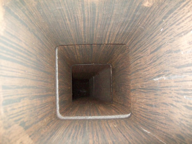 Square tunnel through wooden structure.
