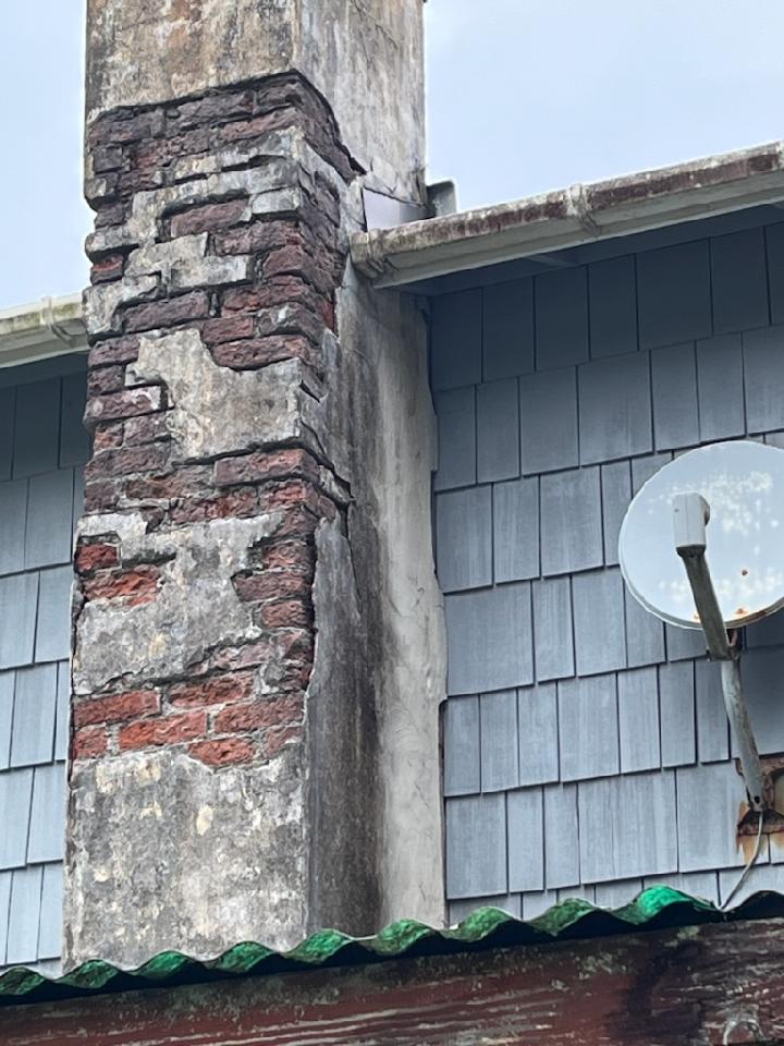 Chimney with freeze and water damage caused by coastal weather.